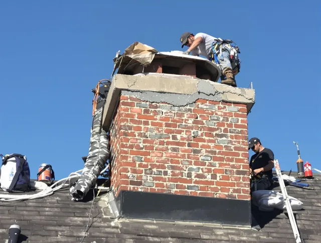 Fairview Park Chimney Sweep installing a custom chimney crown in Fairview Park, OH